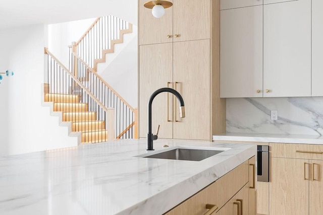 1597 Centre St Unit A, Newton, MA 02461 - kitchen with light brown cabinets, light stone countertops, modern cabinets, and decorative backsplash