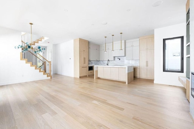 1597 Centre St Unit A, Newton, MA 02461 - kitchen featuring light countertops, light brown cabinetry, and light wood-style floors