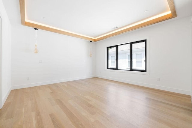 1597 Centre St Unit A, Newton, MA 02461 - unfurnished room featuring a raised ceiling and light wood-style floors