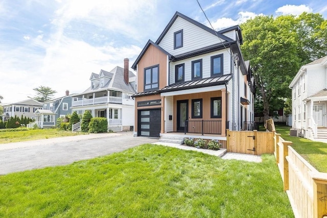 1597 Centre St Unit A, Newton, MA 02461 - view of front of property featuring a porch, a standing seam roof, driveway, a garage, and a metal roof