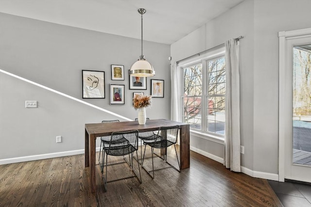 dining area featuring baseboards and wood finished floors