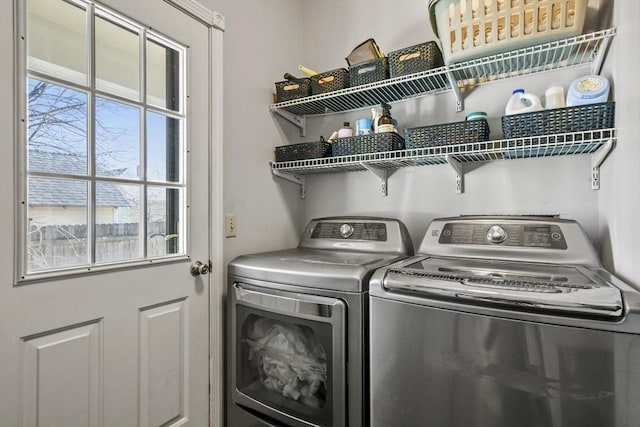 clothes washing area with washing machine and dryer and laundry area