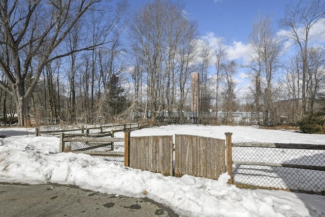 yard layered in snow with fence