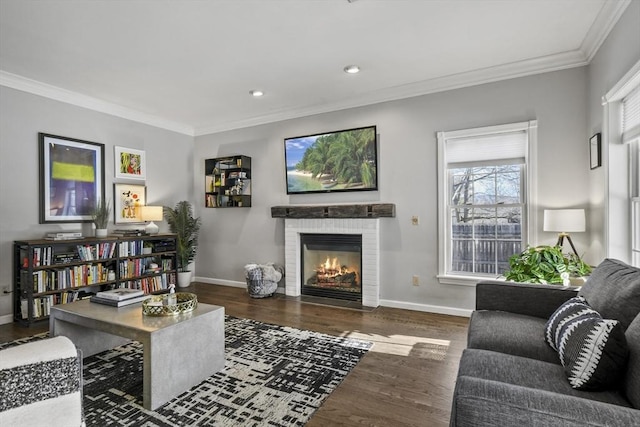 living room with crown molding, wood finished floors, and baseboards