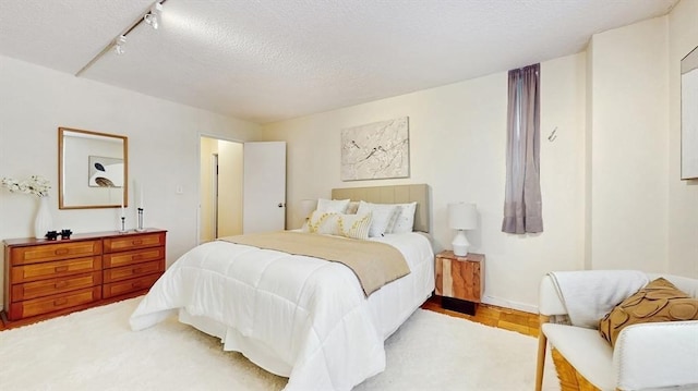 99 Pond Ave Unit 326, Brookline, MA 02445 - bedroom with a textured ceiling and track lighting