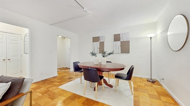 99 Pond Ave Unit 326, Brookline, MA 02445 - dining room featuring a textured ceiling and baseboards