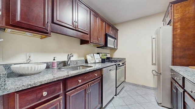 99 Pond Ave Unit 326, Brookline, MA 02445 - kitchen with appliances with stainless steel finishes, a sink, dark brown cabinets, light tile patterned flooring, and light stone counters