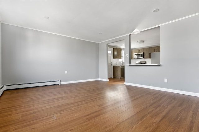 unfurnished living room with hardwood / wood-style flooring, ornamental molding, and baseboard heating