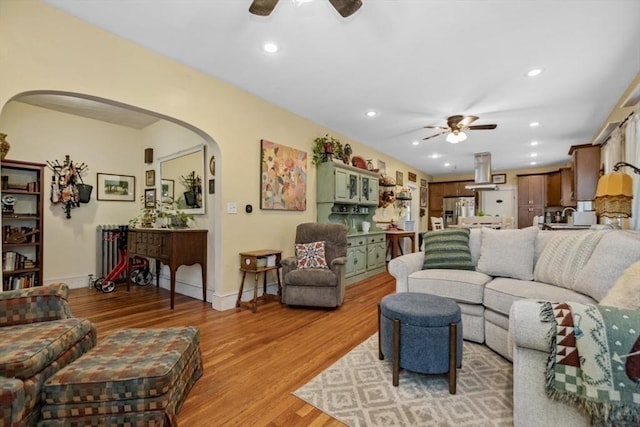 200 Woodside Ave, Winthrop, MA 02152 - living area with ceiling fan, arched walkways, light wood-style floors, recessed lighting, and radiator