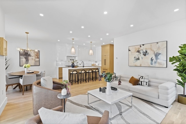 living room with sink and light hardwood / wood-style flooring