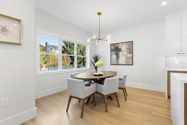 dining area featuring a notable chandelier and light hardwood / wood-style floors