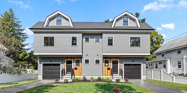 view of front facade with a garage and a front lawn