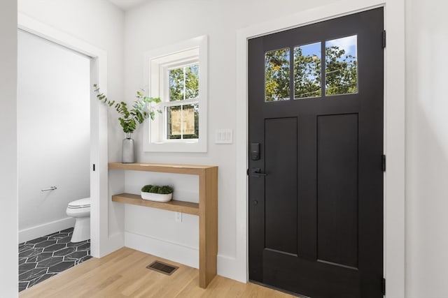 entryway with hardwood / wood-style flooring