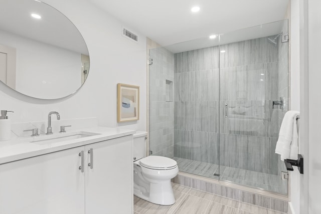 bathroom with walk in shower, wood-type flooring, vanity, and toilet