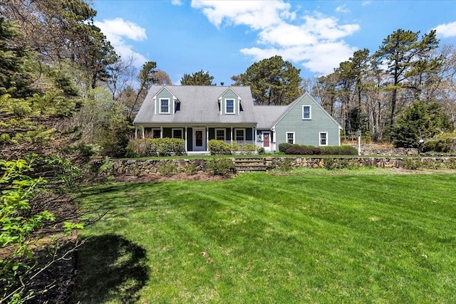 cape cod-style house with covered porch and a front yard