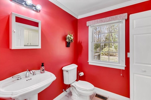 bathroom featuring visible vents, crown molding, a sink, baseboards, and toilet