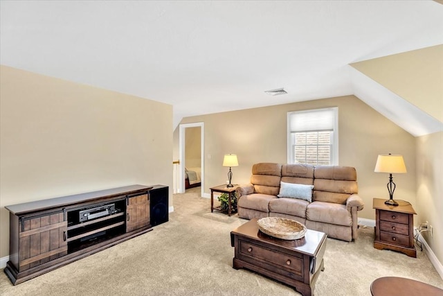 carpeted living area featuring visible vents, baseboards, and lofted ceiling