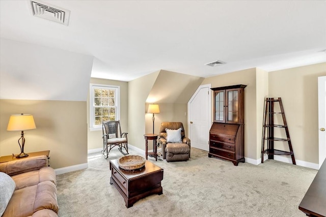 carpeted living area featuring baseboards, lofted ceiling, and visible vents