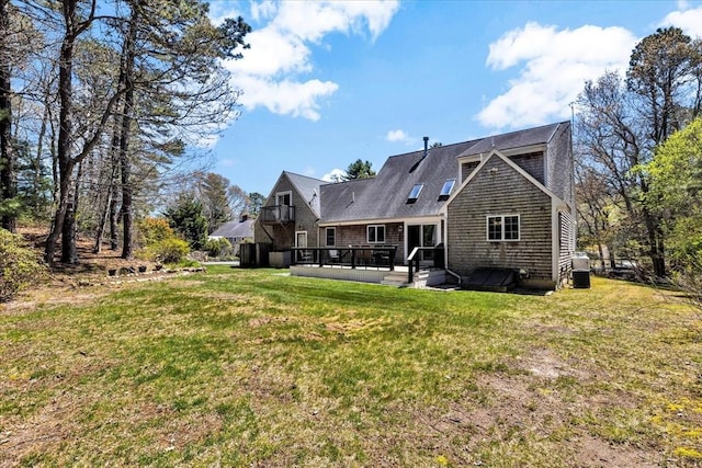 back of property featuring a lawn and a wooden deck