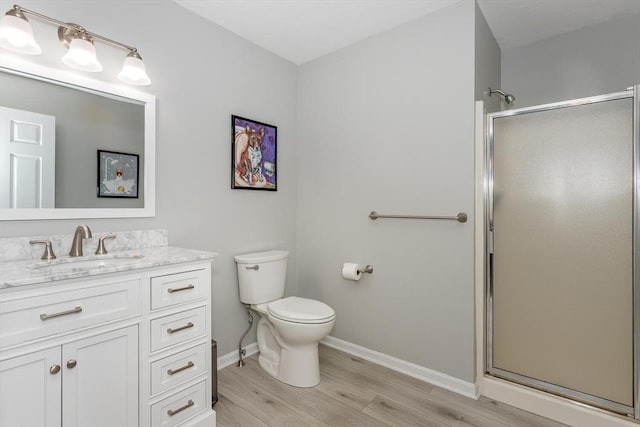 62 Maple St Unit J, Canton, MA 02021 - bathroom featuring wood finished floors, a shower stall, vanity, and baseboards