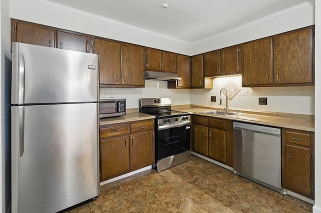 21 Central Ave Unit 30, Everett, MA 02149 - kitchen featuring appliances with stainless steel finishes, under cabinet range hood, crown molding, light countertops, and tasteful backsplash