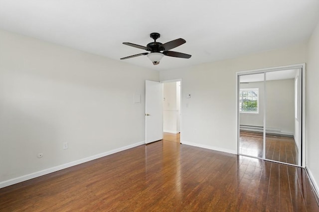 21 Central Ave Unit 30, Everett, MA 02149 - unfurnished bedroom with a baseboard radiator, hardwood / wood-style floors, a closet, and a ceiling fan