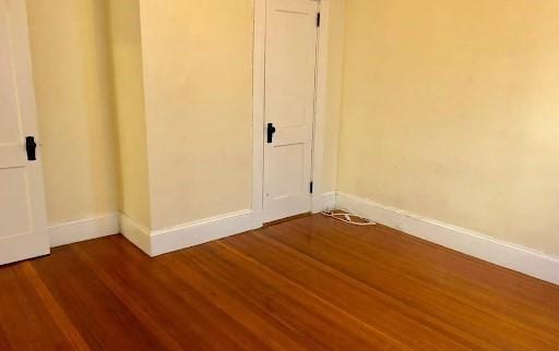 562 Main, Medford, MA 02155 - spare room featuring dark wood-type flooring and baseboards