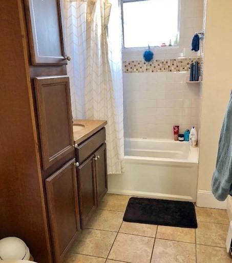 562 Main, Medford, MA 02155 - full bathroom featuring tile patterned floors, shower / bath combo with shower curtain, and vanity