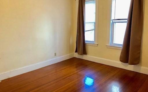 562 Main, Medford, MA 02155 - empty room featuring baseboards and dark wood-style flooring