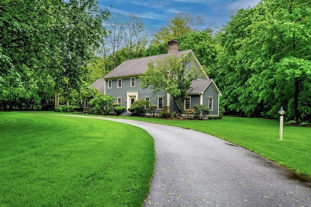 43 Old Concord Rd, Lincoln, MA 01773 - colonial home featuring a front lawn, a chimney, and asphalt driveway