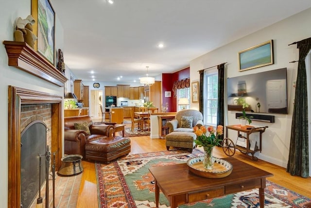 43 Old Concord Rd, Lincoln, MA 01773 - living area with light wood-style flooring, a brick fireplace, recessed lighting, and baseboards