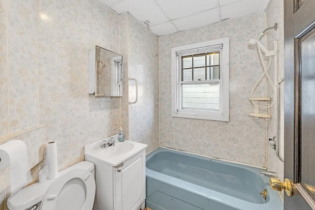 full bathroom with a paneled ceiling, bathtub / shower combination, vanity, and toilet