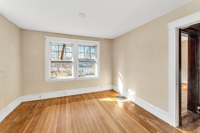 unfurnished room with wood-type flooring