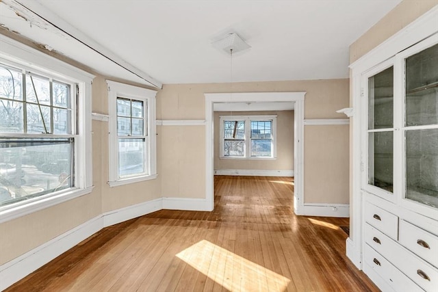 unfurnished dining area featuring wood-type flooring