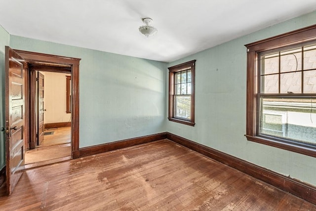 spare room with wood-type flooring