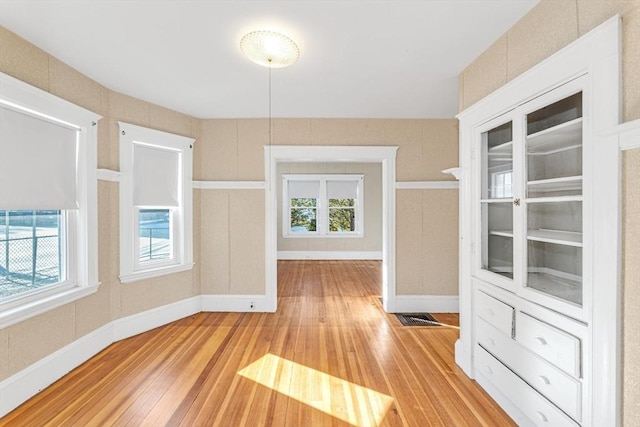 unfurnished dining area with light hardwood / wood-style flooring