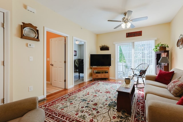 living room featuring ceiling fan and light hardwood / wood-style floors