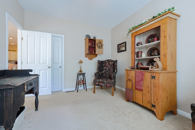 living area with light colored carpet