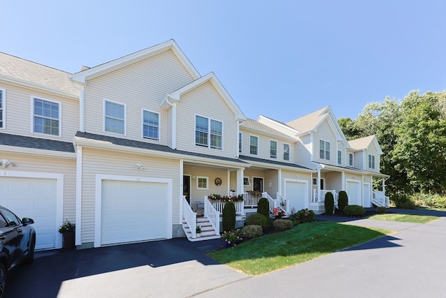 townhome / multi-family property featuring a garage and covered porch