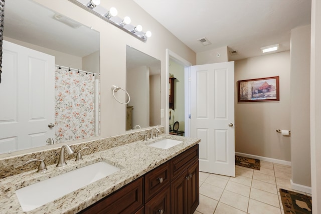 bathroom with tile patterned flooring and vanity