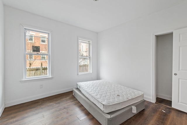 bedroom with dark hardwood / wood-style flooring