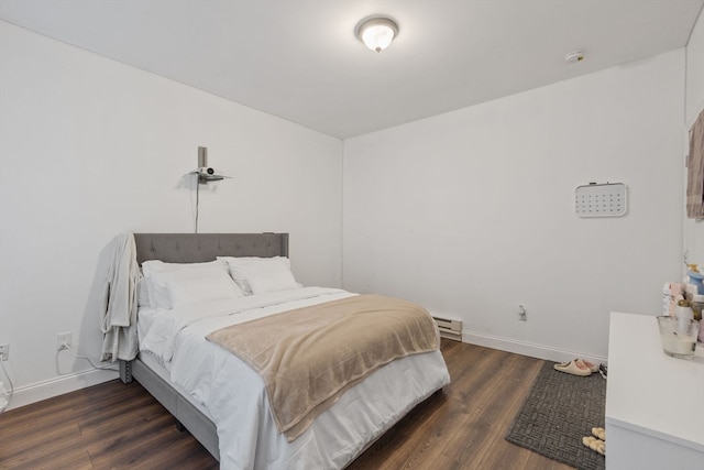 bedroom featuring dark wood-type flooring and baseboard heating