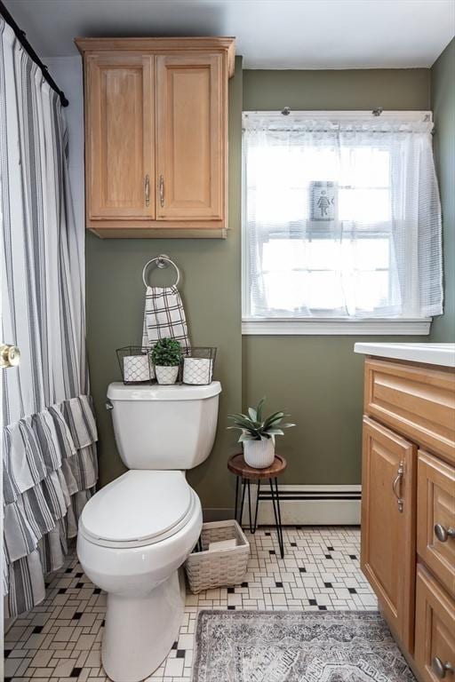 full bath featuring a baseboard heating unit, vanity, and toilet