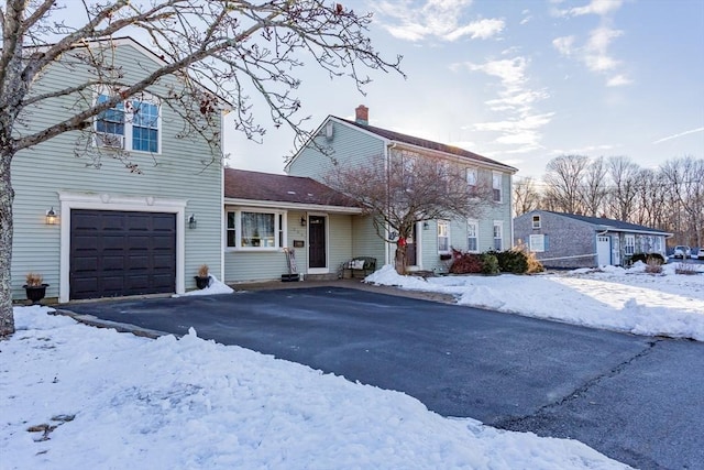 view of front of home featuring aphalt driveway and a garage