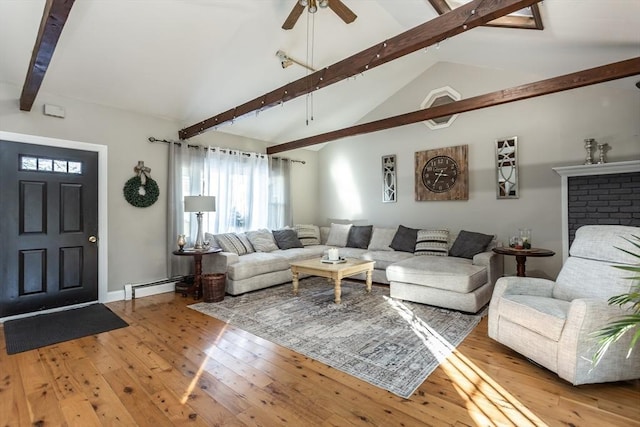 living room with vaulted ceiling with beams, light wood finished floors, ceiling fan, and baseboard heating