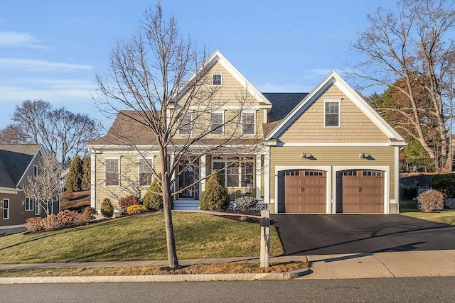 view of front facade with a front yard and a garage