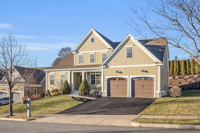 craftsman house with a garage and a front lawn