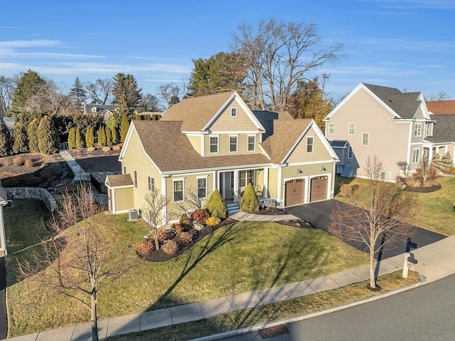 view of front of home with a front yard and a garage