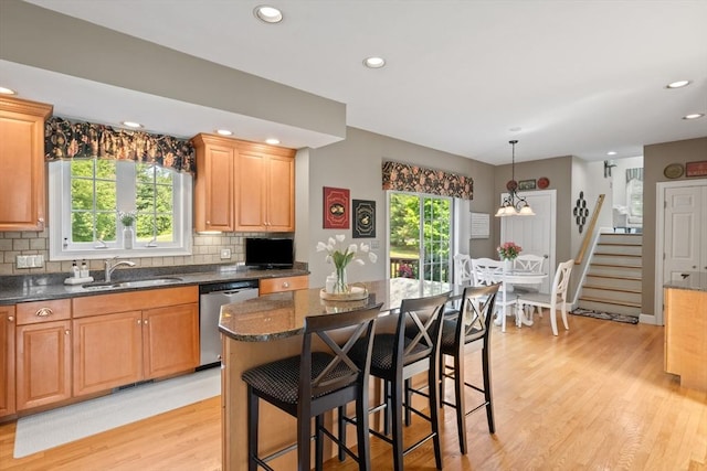 356 Grafton St, Shrewsbury, MA 01545 - kitchen featuring stainless steel dishwasher, light wood-style flooring, recessed lighting, backsplash, and a breakfast bar area