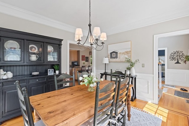 356 Grafton St, Shrewsbury, MA 01545 - dining room featuring light wood-type flooring, crown molding, a chandelier, and a wainscoted wall